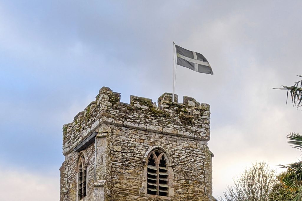 Cornish flag flying on St Just In Roseland church