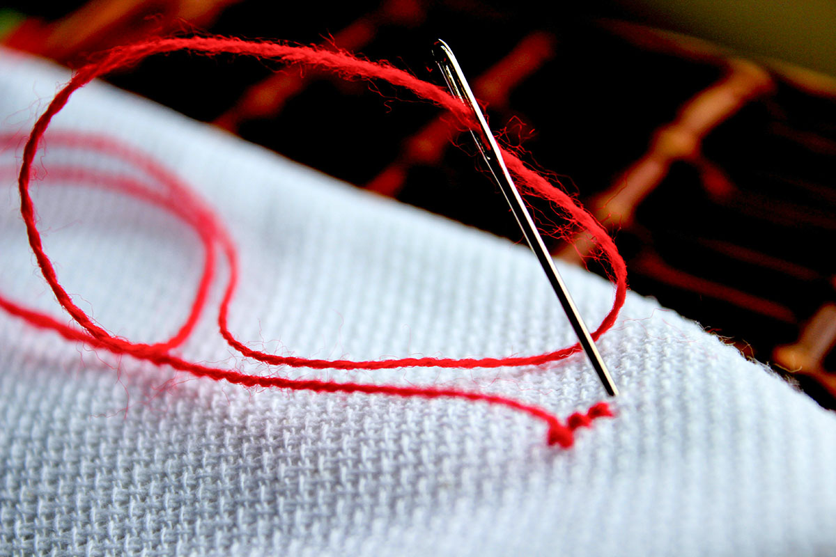 sewing needle and red thread