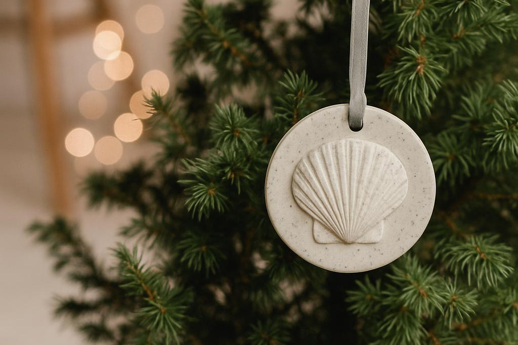 Resin cast christmas decoration of a sea shell hanging on a christmas tree