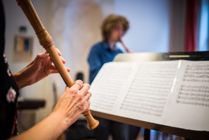 Person playing the recorder and sheet music