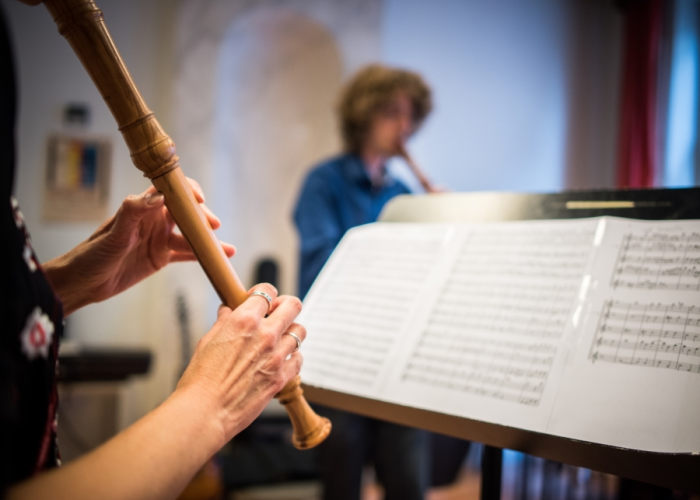 Person playing the recorder and sheet music