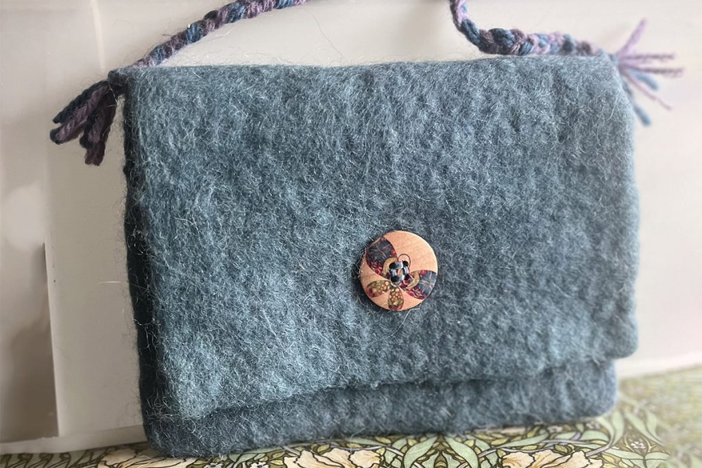 A wet felt-made bag with a button